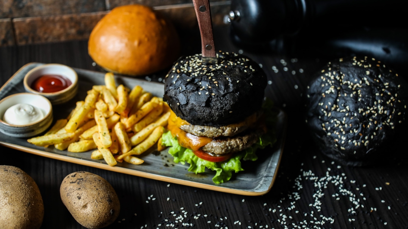 beef burger lettuce tomato french fries sauces side view