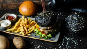 beef burger lettuce tomato french fries sauces side view