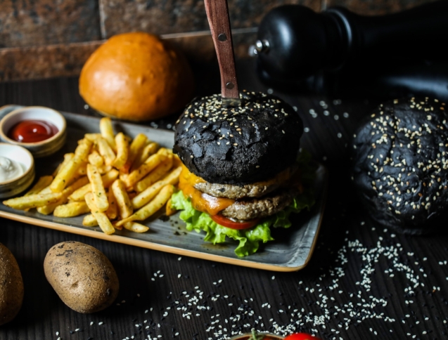 beef burger lettuce tomato french fries sauces side view